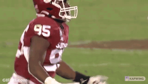 A Football Player Wearing A Number 95 Jersey GIF