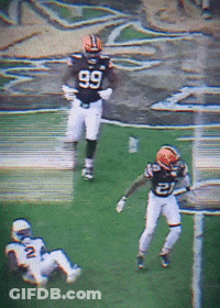 A Football Player Wearing A Number 99 Jersey Runs On The Field GIF