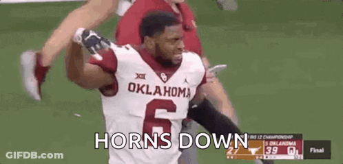 A Football Player Wearing A Oklahoma Jersey Is Running On A Field . GIF