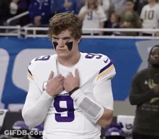 A Football Player Wearing A Purple And White Jersey With The Number 9 On It . GIF