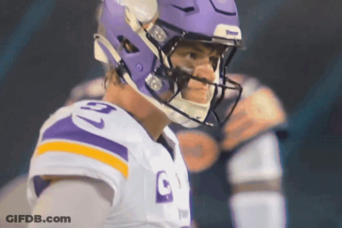 A Football Player Wearing A Purple Helmet And A Jersey With The Number 9 On It GIF