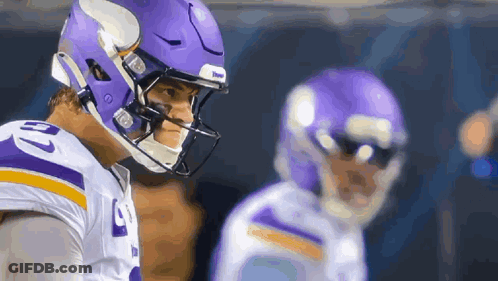 A Football Player Wearing A Purple Helmet Has The Number 10 On His Shirt GIF