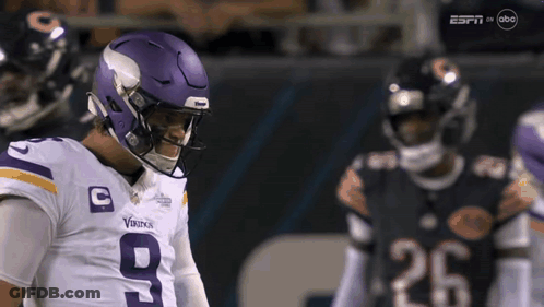 A Football Player Wearing A Purple Helmet With The Number 9 On It GIF