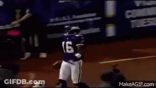 A Football Player Wearing A Purple Jersey And Helmet Is Running With A Ball On A Field . GIF