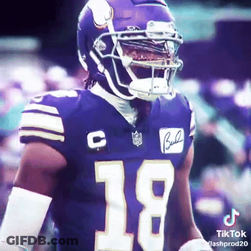 A Football Player Wearing A Purple Jersey With The Number 18 GIF