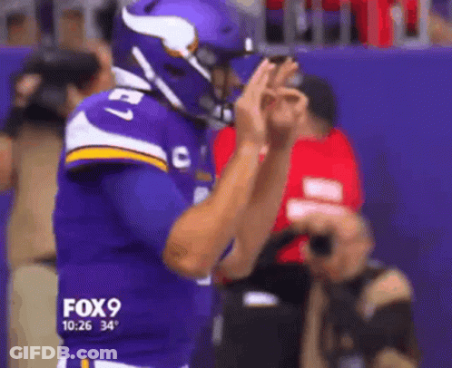 A Football Player Wearing A Purple Jersey With The Number 27 GIF