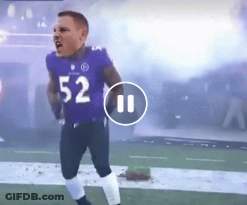 A Football Player Wearing A Purple Uniform With The Number 52 On It GIF