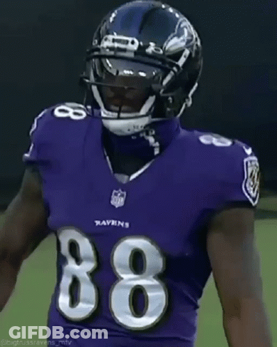 A Football Player Wearing A Purple Uniform With The Number 86 On It GIF
