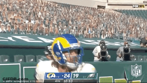 A Football Player Wearing A Rams Helmet Stands In Front Of A Crowd GIF