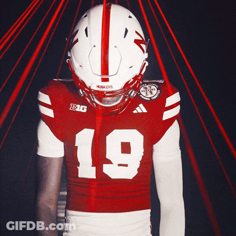 A Football Player Wearing A Red And White Jersey With The Number 19 On It GIF
