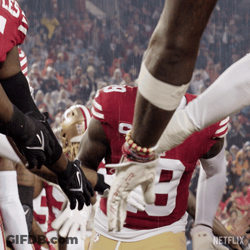 A Football Player Wearing A Red And White Jersey With The Number 8 On It GIF