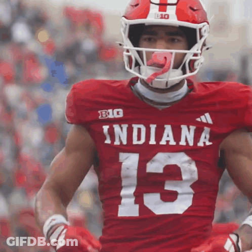 A Football Player Wearing A Red Indiana Jersey With The Number 13 On It GIF