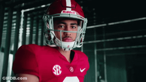 A Football Player Wearing A Red Jersey And A Riddell Helmet Looks At The Camera GIF