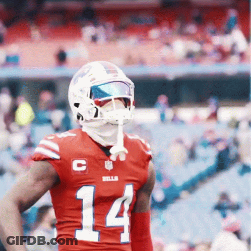 A Football Player Wearing A Red Jersey With The Number 14 On The Front GIF
