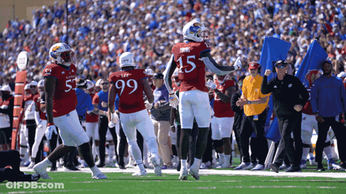 A Football Player Wearing A Red Jersey With The Number 15 On It GIF