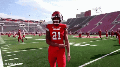A Football Player Wearing A Red Jersey With The Number 21 GIF