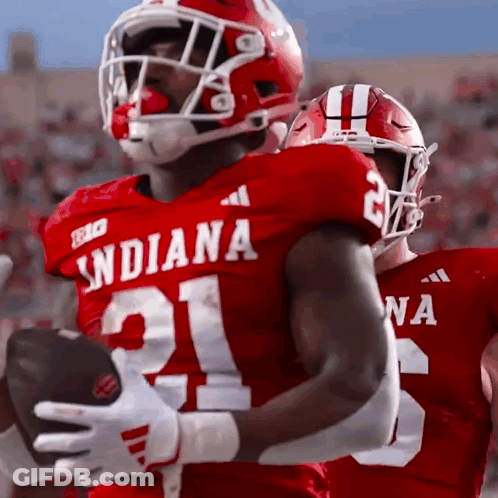 A Football Player Wearing A Red Jersey With The Number 21 On It GIF