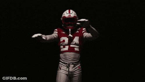 A Football Player Wearing A Red Jersey With The Number 24 GIF