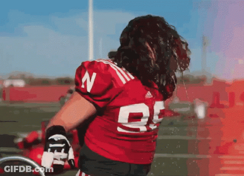 A Football Player Wearing A Red Jersey With The Number 25 On It GIF