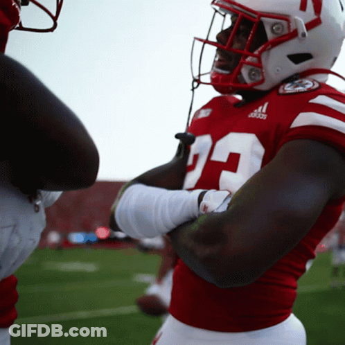 A Football Player Wearing A Red Jersey With The Number 29 GIF