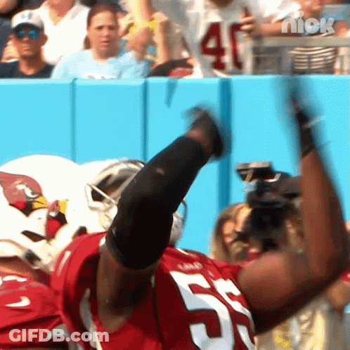 A Football Player Wearing A Red Jersey With The Number 57 On It GIF
