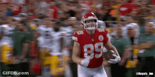 A Football Player Wearing A Red Jersey With The Number 89 On It GIF