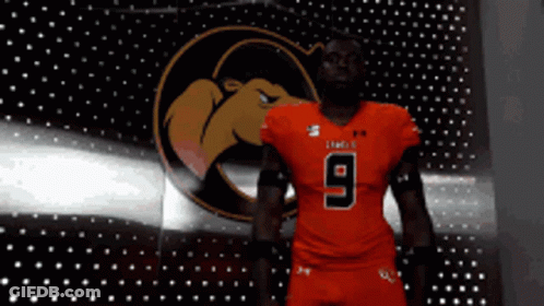 A Football Player Wearing A Red Jersey With The Number 9 GIF