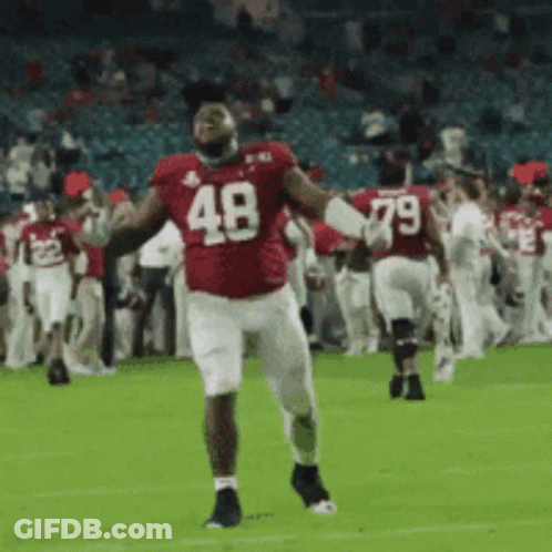 A Football Player Wearing A Red Uniform With The Number 48 On It GIF