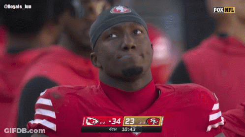 A Football Player Wearing A San Francisco 49Ers Jersey Watches A Game GIF