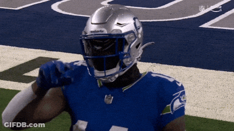 A Football Player Wearing A Seahawks Jersey And Helmet GIF