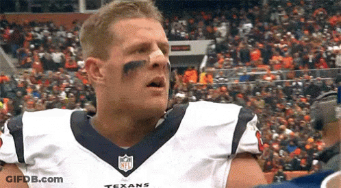 A Football Player Wearing A Texans Jersey Is Standing In Front Of A Crowd Of People . GIF