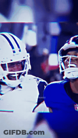 A Football Player Wearing A White Helmet Is Talking To Another Player Wearing A Blue Helmet GIF