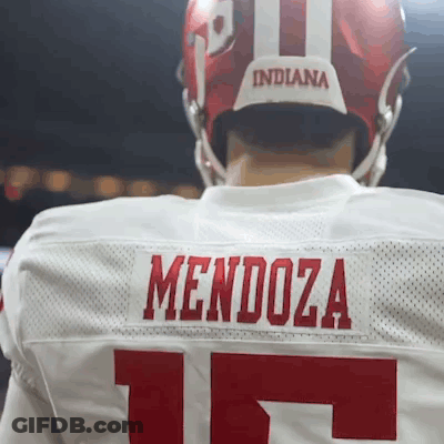 A Football Player Wearing A White Jersey With The Name Mendoza On The Back GIF