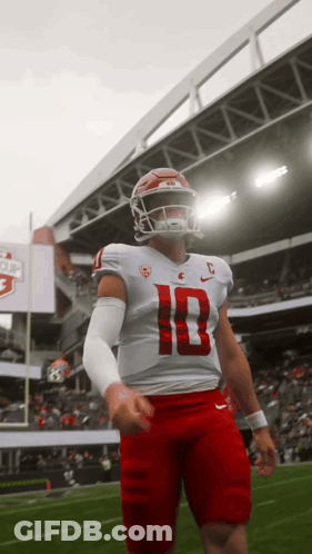 A Football Player Wearing A White Jersey With The Number 10 On It GIF