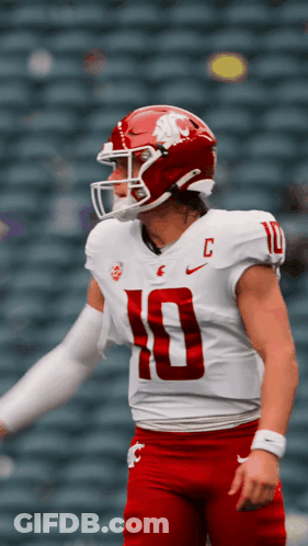 A Football Player Wearing A White Jersey With The Number 10 On The Front GIF