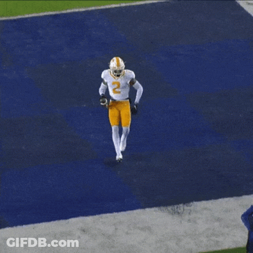 A Football Player Wearing A White Jersey With The Number 2 On It GIF