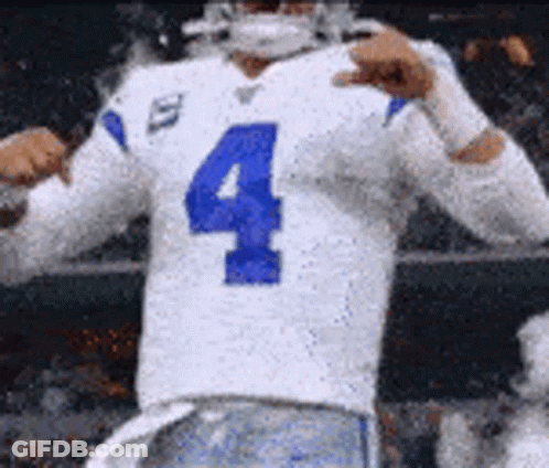 A Football Player Wearing A White Jersey With The Number Four On It Is Giving A Thumbs Up . GIF