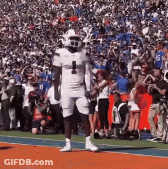 A Football Player Wearing A White Uniform With The Number 1 On It GIF