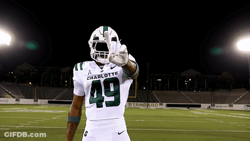 A Football Player Wearing A White Uniform With The Number 49 On It GIF