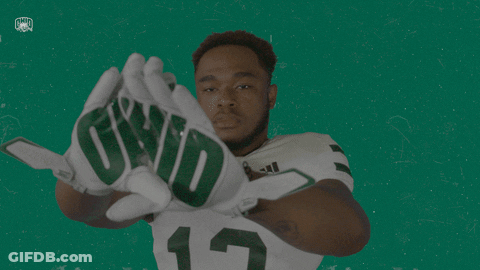A Football Player Wearing Gloves That Say Qwd GIF