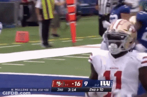 A Football Player Wearing Number 11 Stands On The Field During A Game GIF