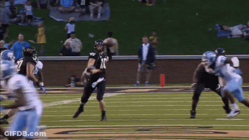 A Football Player Wearing Number 18 Throws The Ball GIF