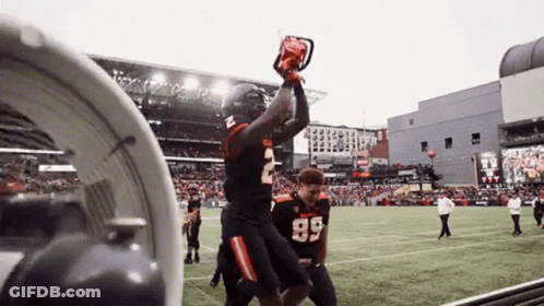 A Football Player Wearing Number 2 Is Holding A Chainsaw In His Hand GIF