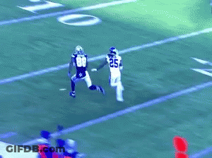 A Football Player Wearing Number 33 Is Trying To Catch A Pass GIF