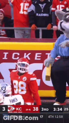 A Football Player Wearing Number 38 Stands In Front Of A Crowd GIF