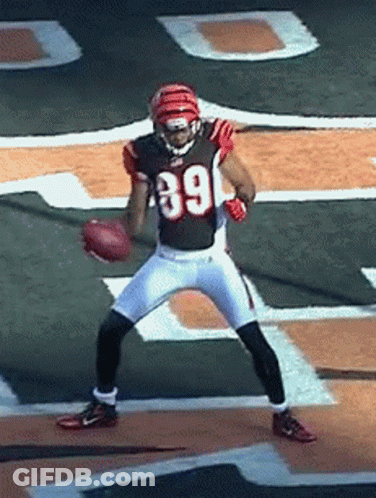 A Football Player Wearing Number 39 Is Holding A Football GIF
