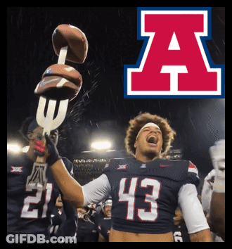 A Football Player Wearing Number 43 Holds Up A Trophy GIF