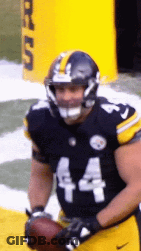 A Football Player Wearing Number 44 Holds A Football GIF