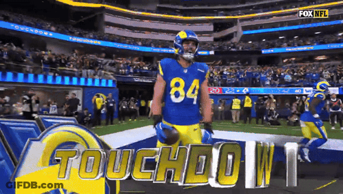 A Football Player Wearing Number 84 Stands On The Field GIF