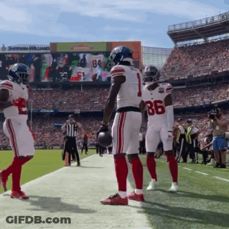 A Football Player Wearing Number 86 Stands On The Sidelines GIF